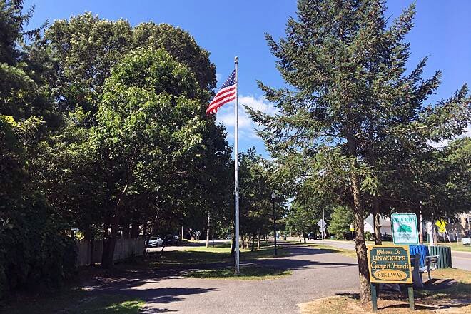 Tree-lined Shore Road Bikeway through a residential area of Linwood, New Jersey.