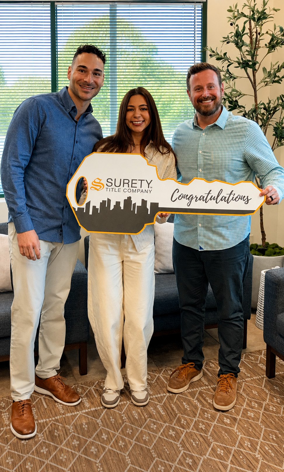 Matt Giroud with a homebuyer and closing representative at a closing celebration