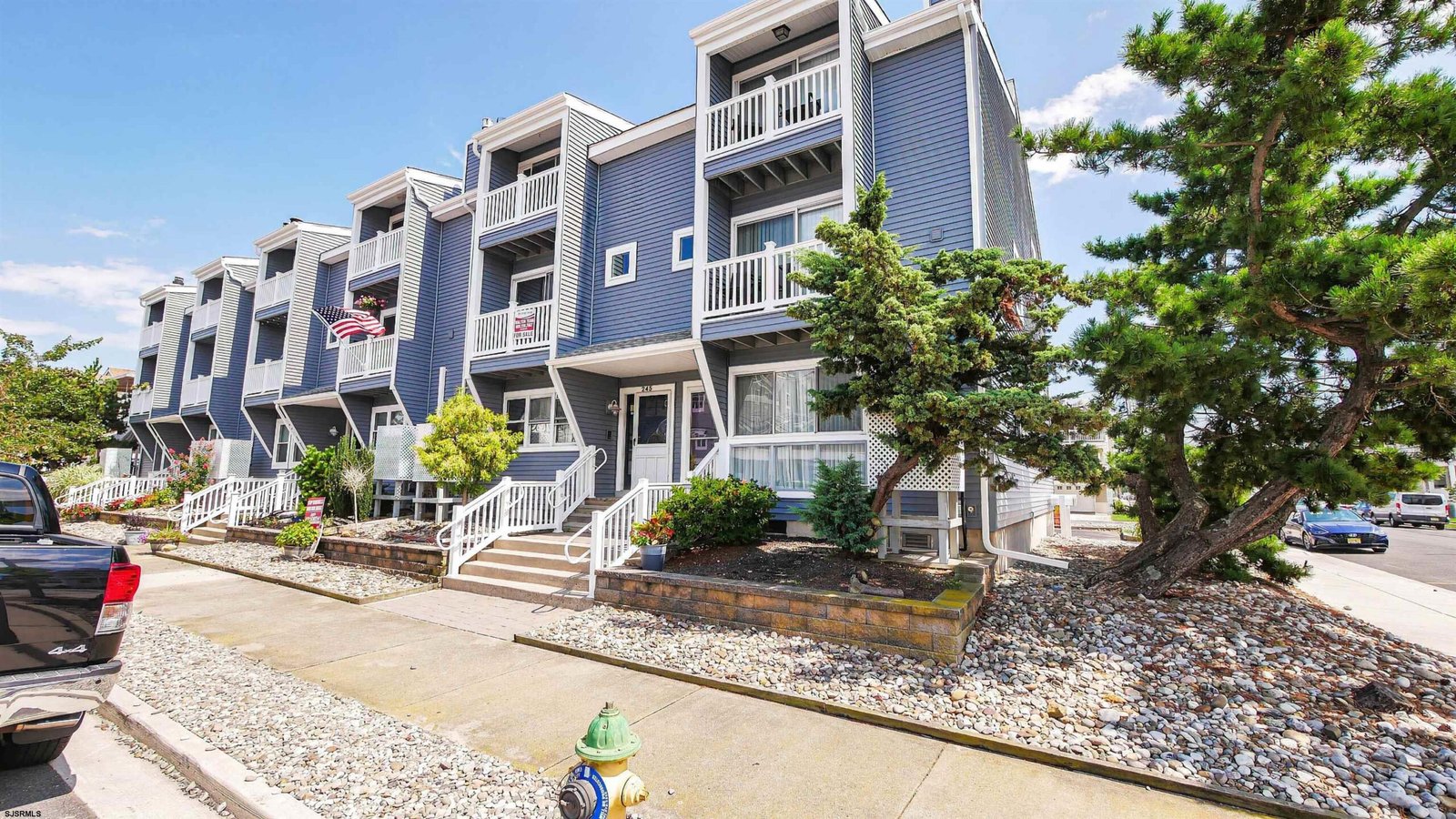 Blue coastal-style condo townhomes with balconies in Ocean City, New Jersey