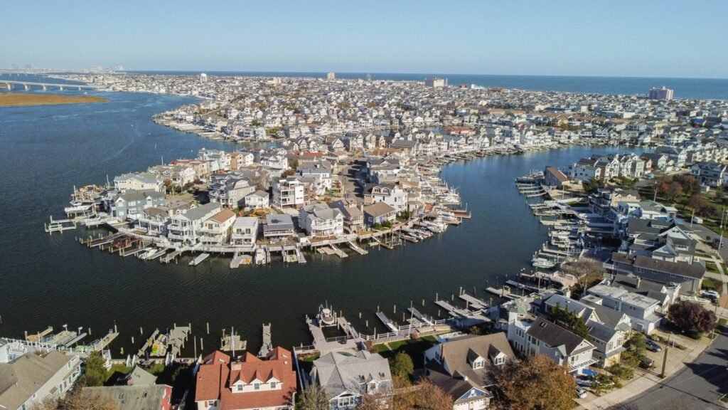 Aerial view of Ocean City, New Jersey showing bayfront lagoons, residential neighborhoods and the Atlantic Ocean in the distance.