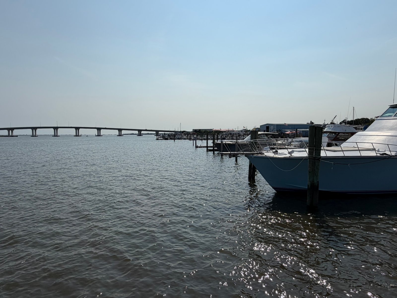 Boats at a Somers Point marina with the Route 52 bridge to Ocean City in the background.