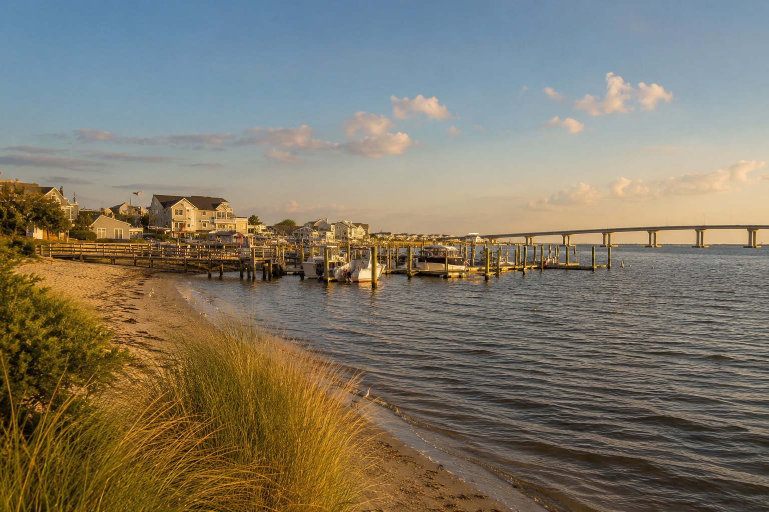 Golden-hour view of the Somers Point waterfront, marina and Route 52 bridge toward Ocean City.